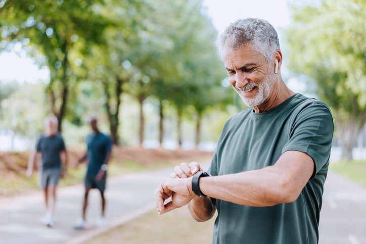 man looking at watch smiling 