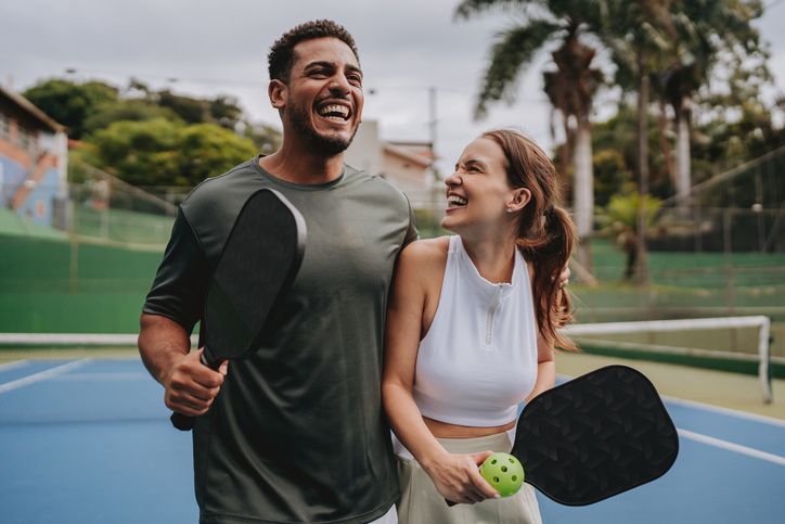 man and woman playing pickle ball