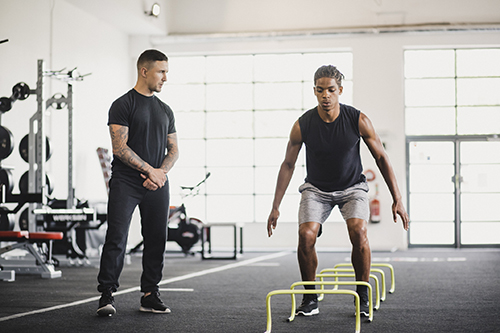 Man working out under supervision